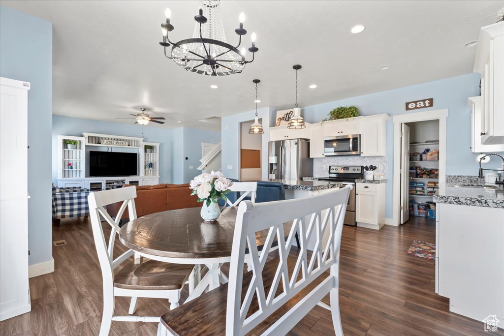 Dining area with a chandelier, dark wood-style floors, recessed lighting, and ceiling fan