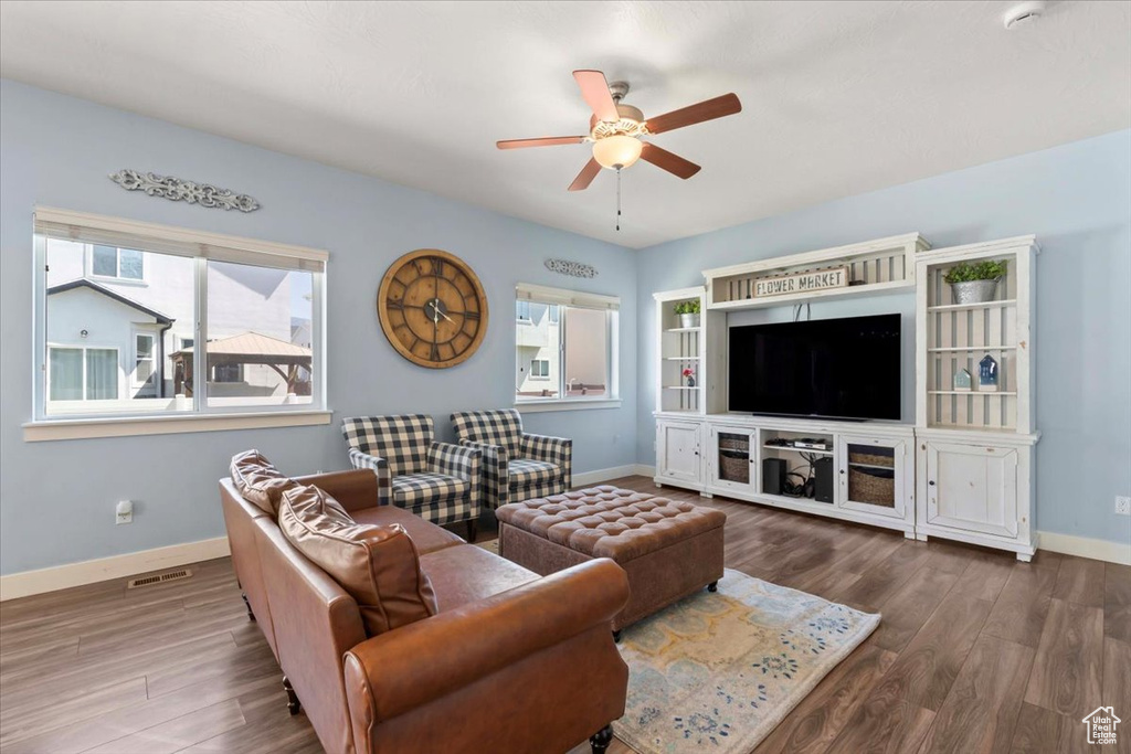 Living room featuring ceiling fan and wood finished floors