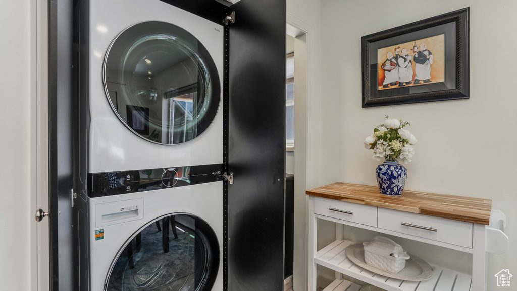 Washroom featuring stacked washer and clothes dryer