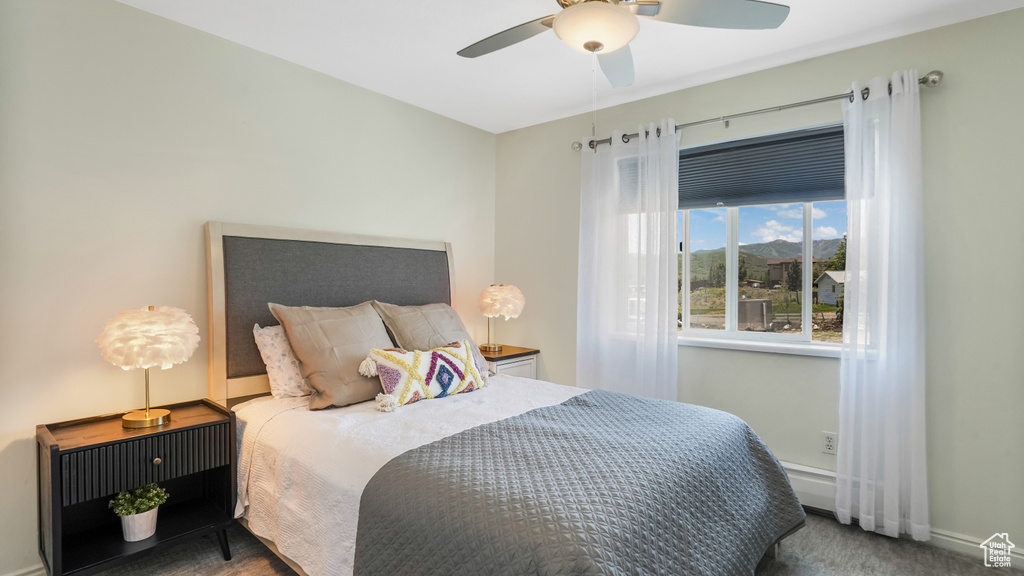 Carpeted bedroom with baseboards and a ceiling fan