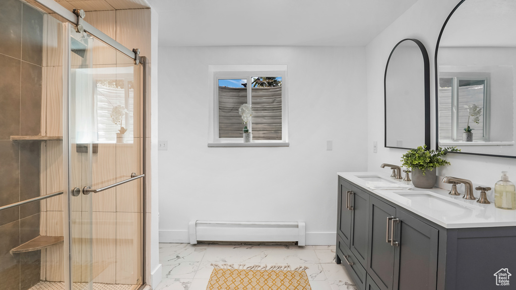 Bathroom featuring a baseboard radiator, marble look tiles, double vanity, and a shower stall