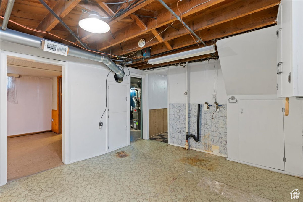 Unfinished basement featuring tile patterned floors