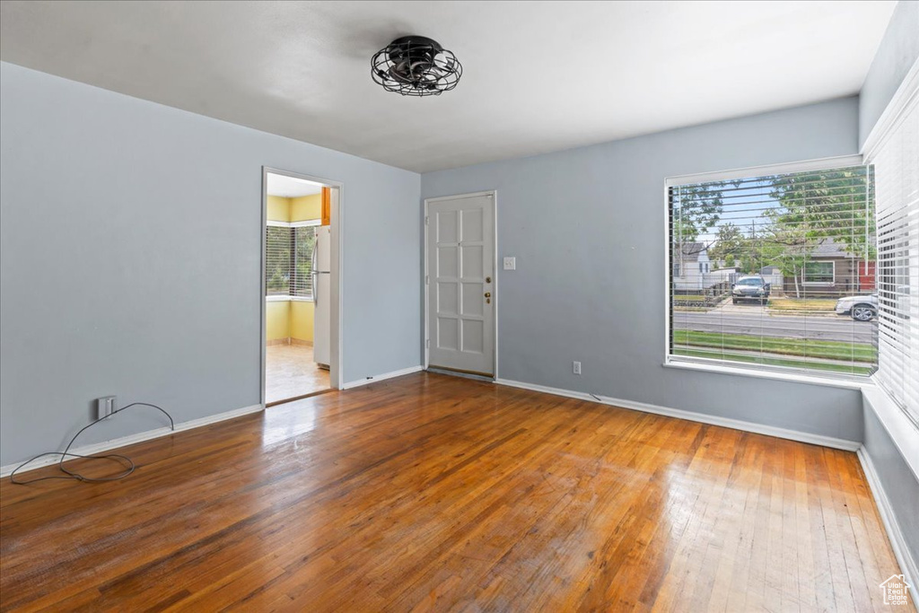 Empty room with hardwood / wood-style flooring