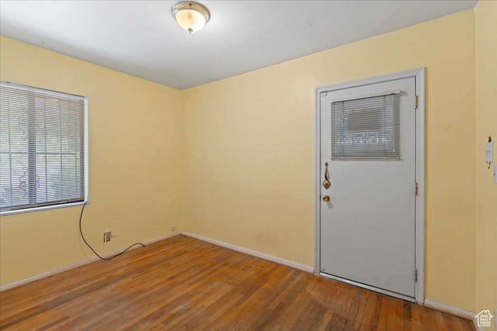 Unfurnished room featuring wood finished floors and baseboards