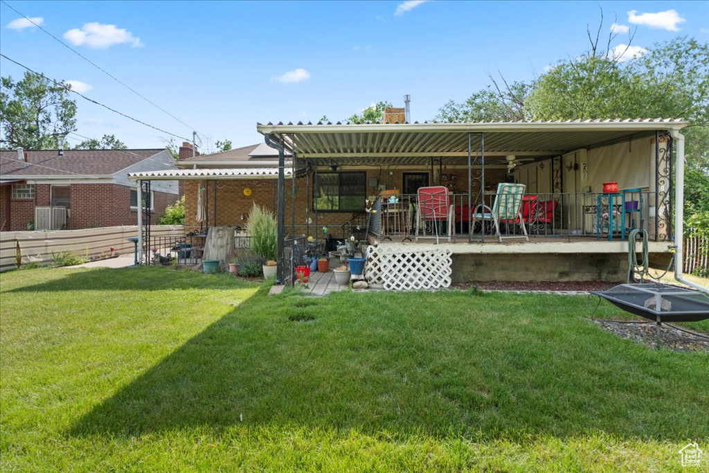 Back of property featuring a chimney and covered porch