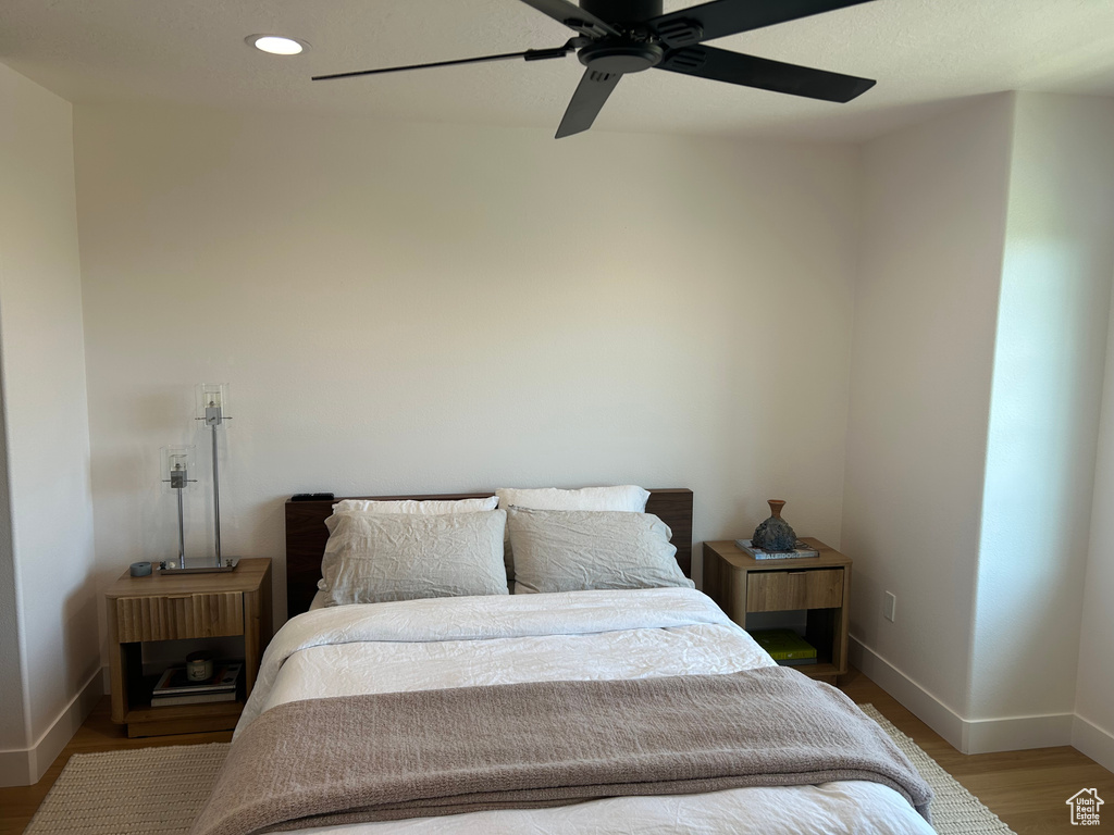 Bedroom with light wood-type flooring, recessed lighting, and ceiling fan