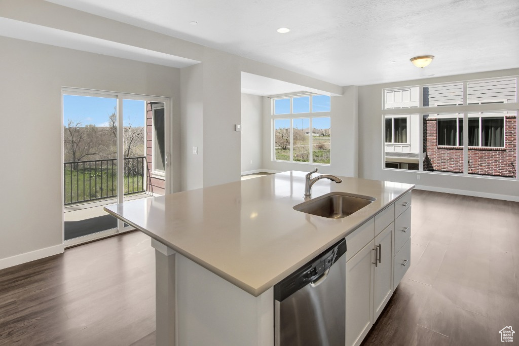 Kitchen featuring dishwasher, plenty of natural light, open floor plan, wood finished floors, and recessed lighting