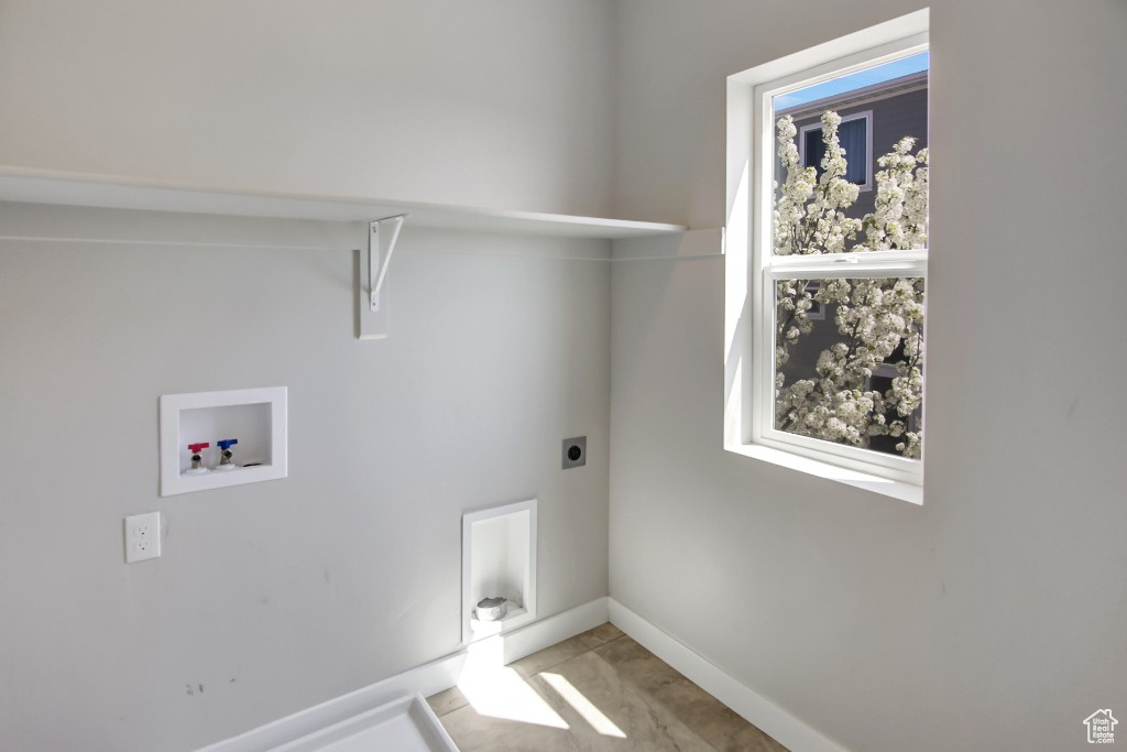 Laundry area featuring hookup for an electric dryer and hookup for a washing machine