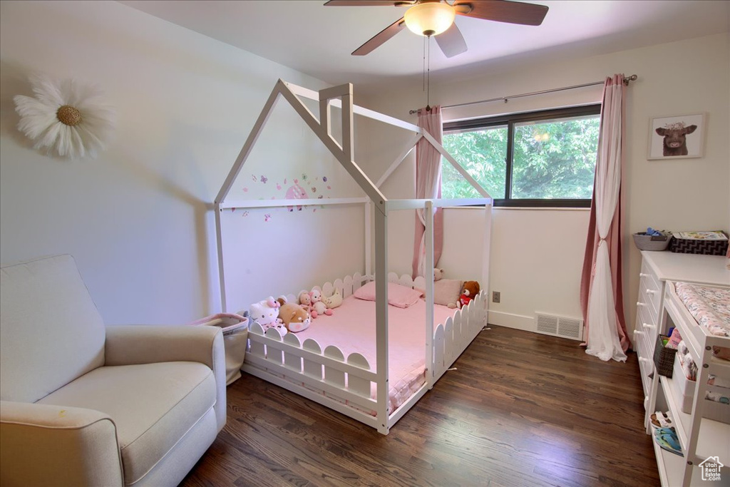Bedroom with wood finished floors and a ceiling fan