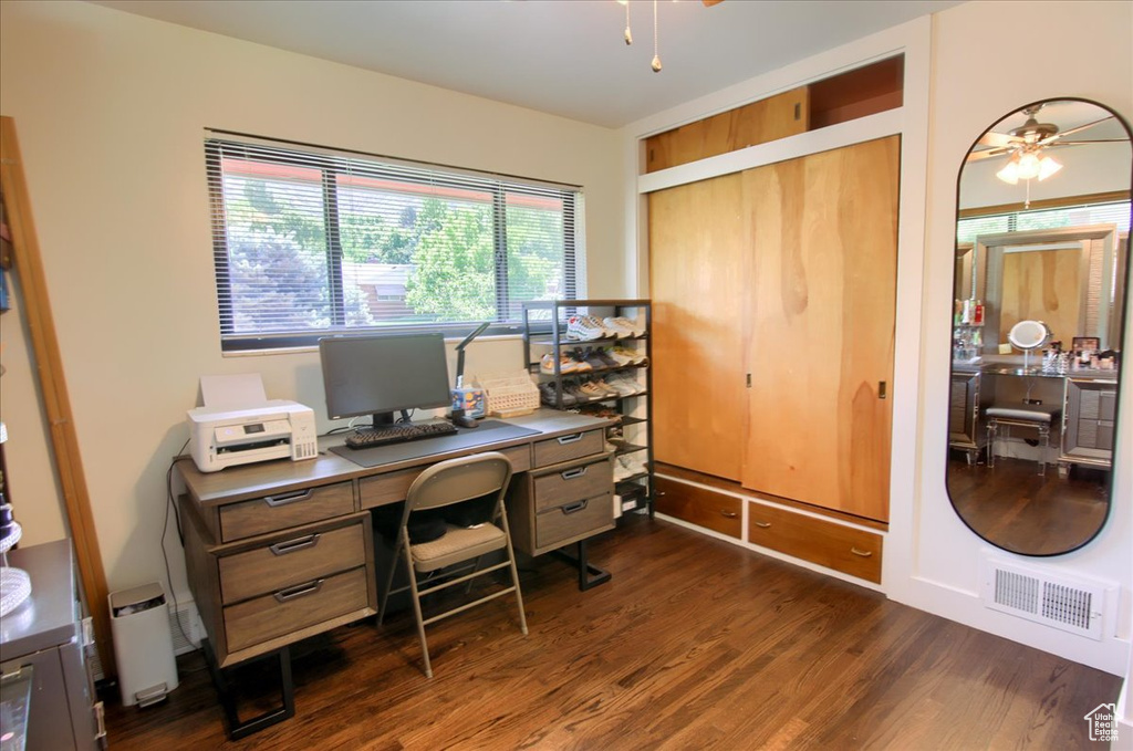 Office featuring dark wood-type flooring and ceiling fan