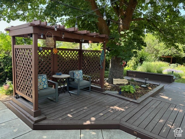 Deck featuring a pergola