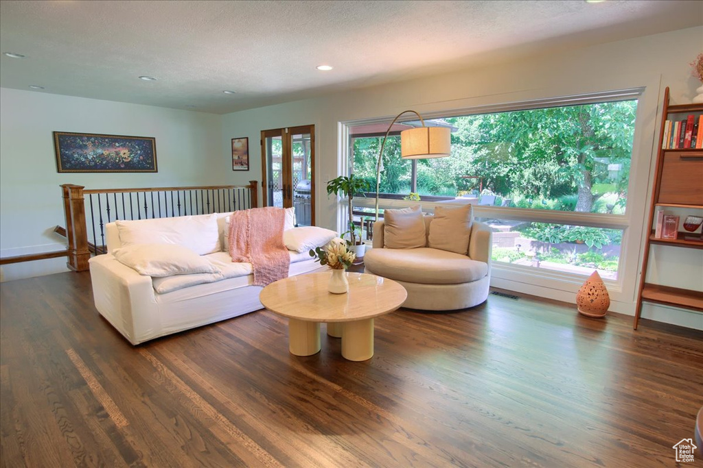 Living area featuring wood finished floors, recessed lighting, and french doors