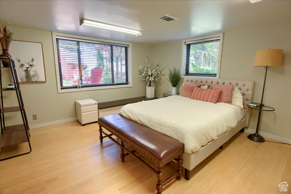 Bedroom with light wood-style floors and baseboards