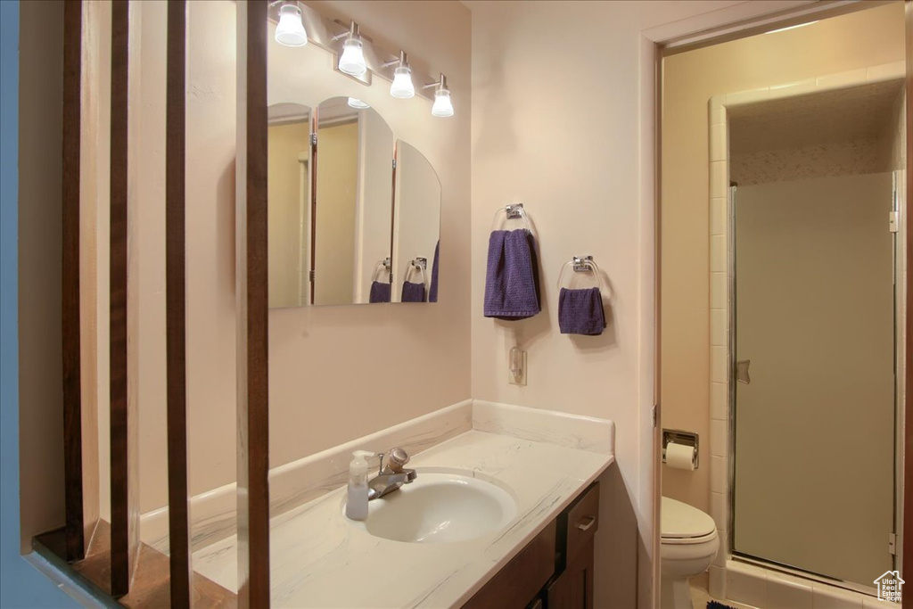 Full bath with vanity and a shower stall