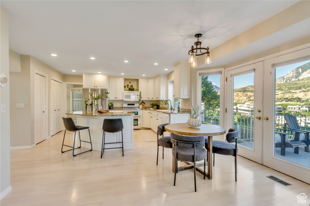 Dining room with healthy amount of natural light, french doors, and recessed lighting