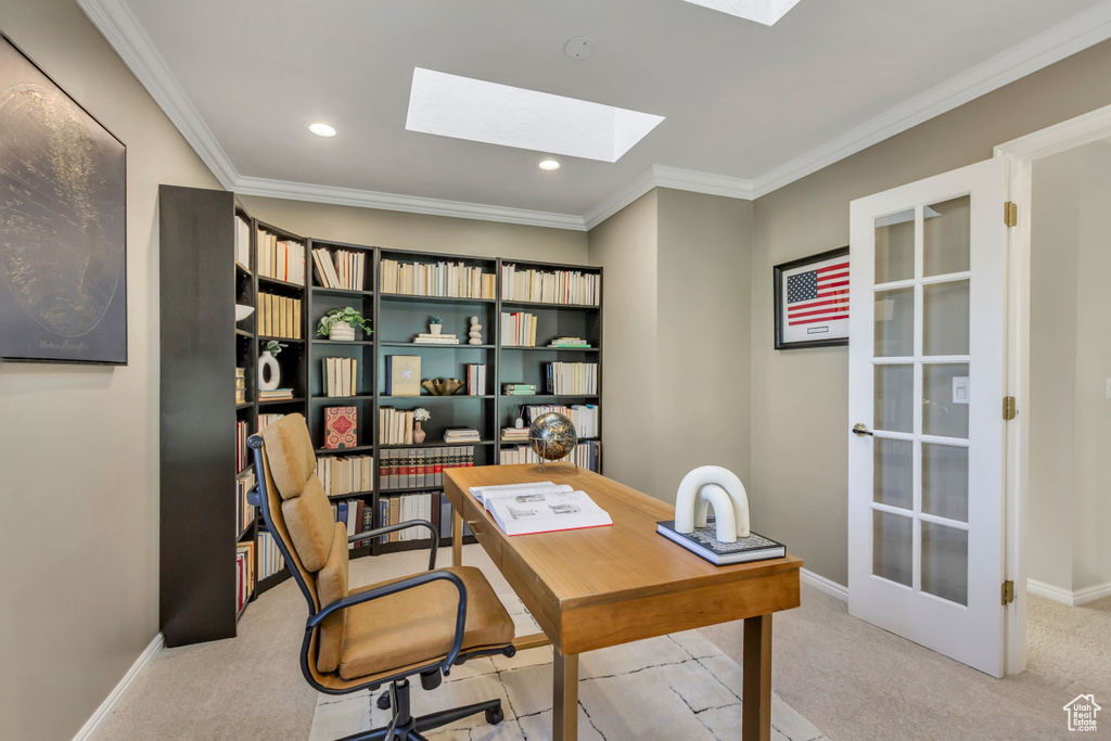 Office space with a skylight, carpet floors, crown molding, and recessed lighting