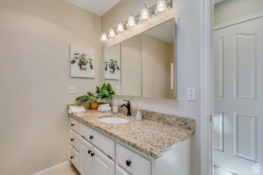 Bathroom with vanity and baseboards