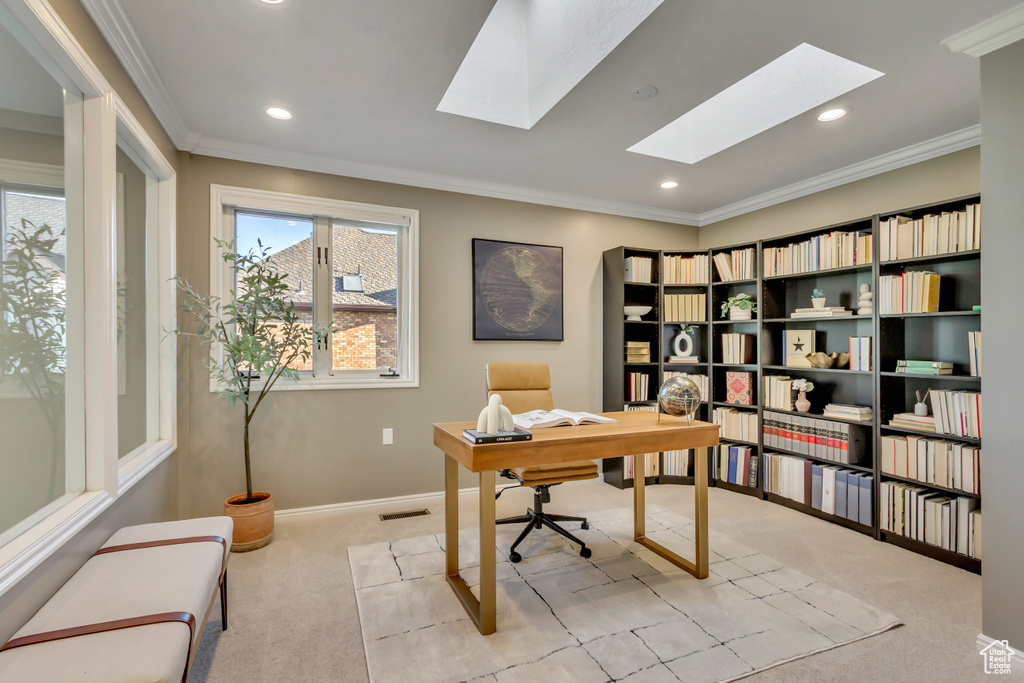 Office featuring light carpet, a skylight, crown molding, and recessed lighting