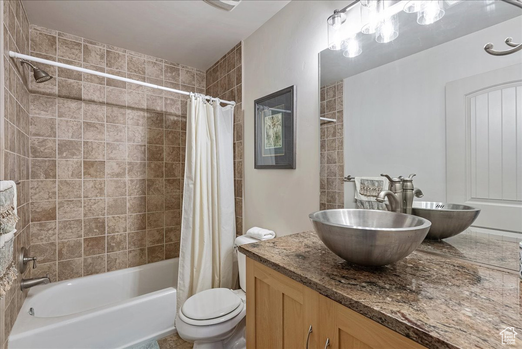 Full bathroom featuring vanity and shower / bath combination with curtain