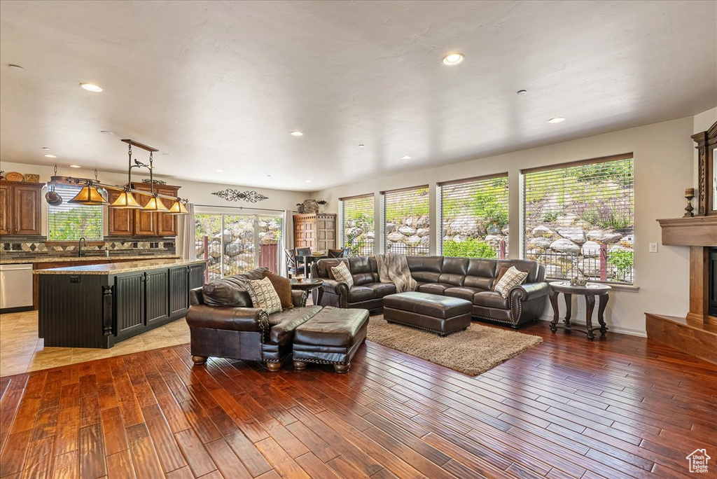 Living room featuring wood-type flooring, a high end fireplace, and recessed lighting