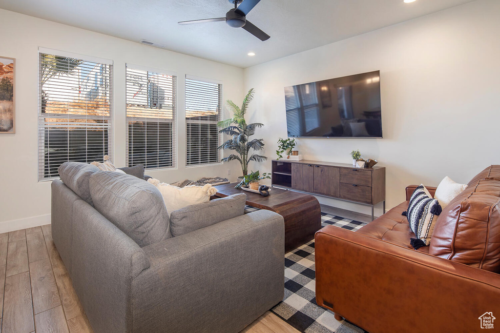 Living room featuring ceiling fan, recessed lighting, and light wood-type flooring