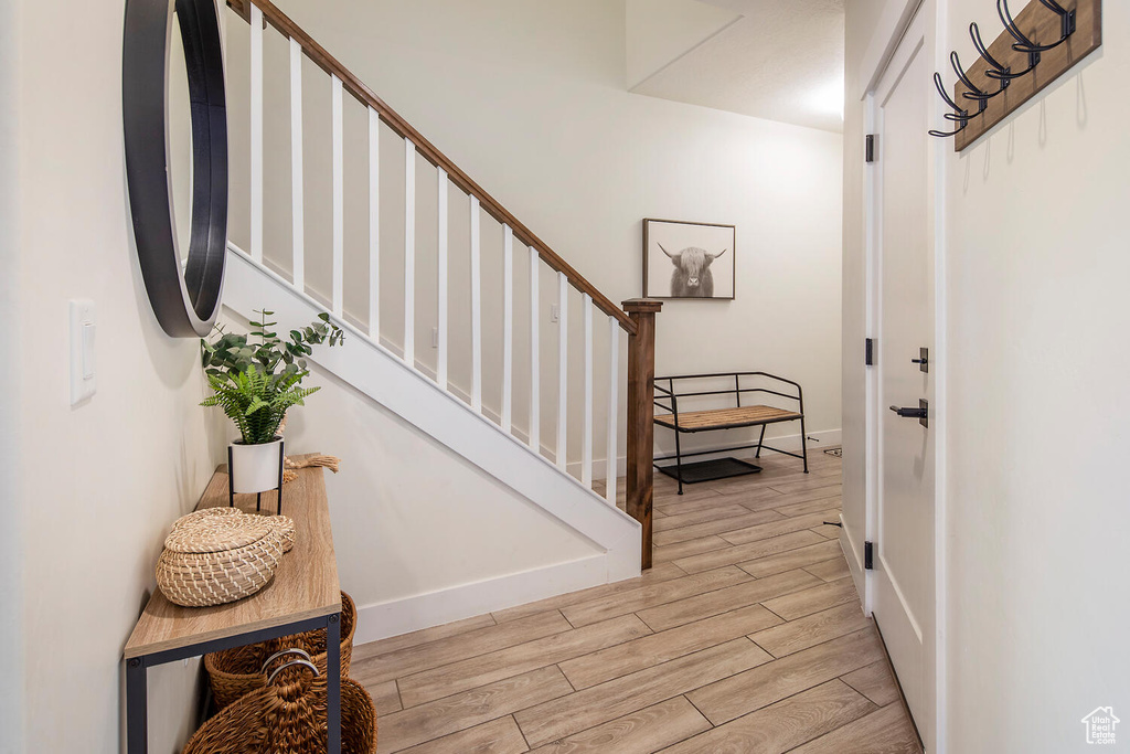Entryway featuring wood finished floors and stairs