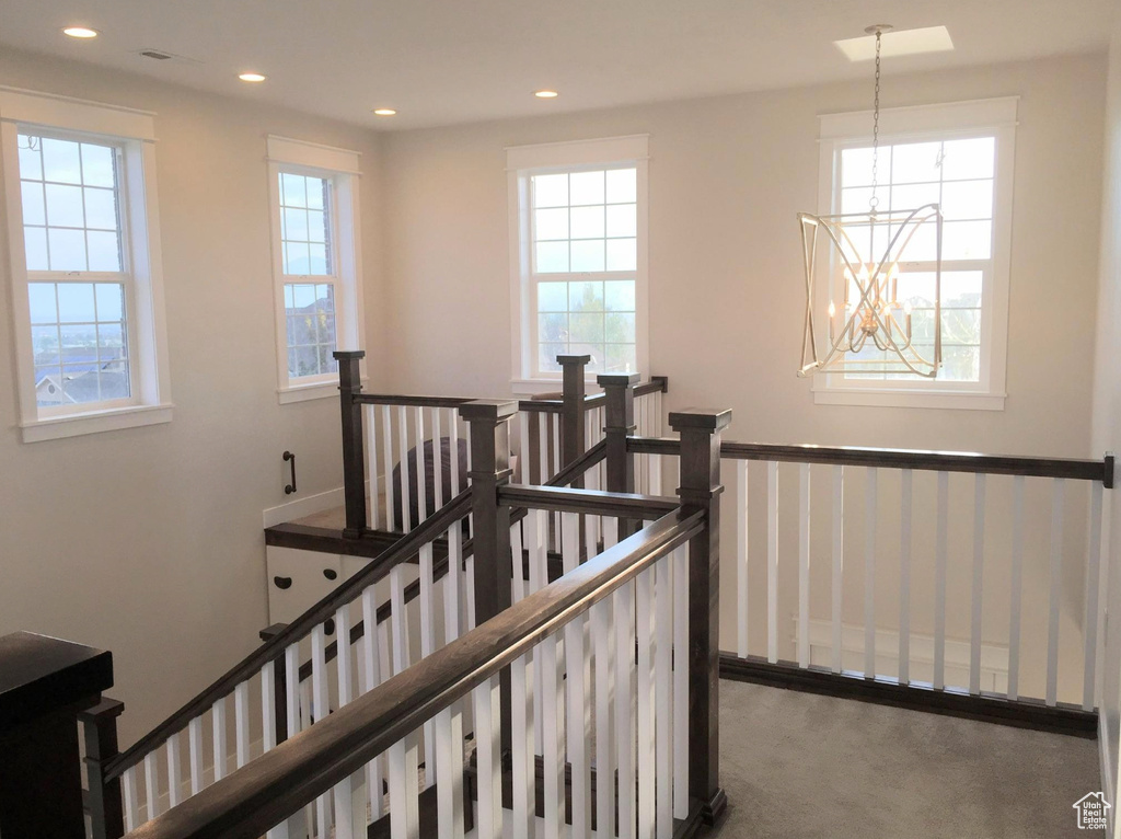 Staircase with a chandelier, carpet floors, and recessed lighting