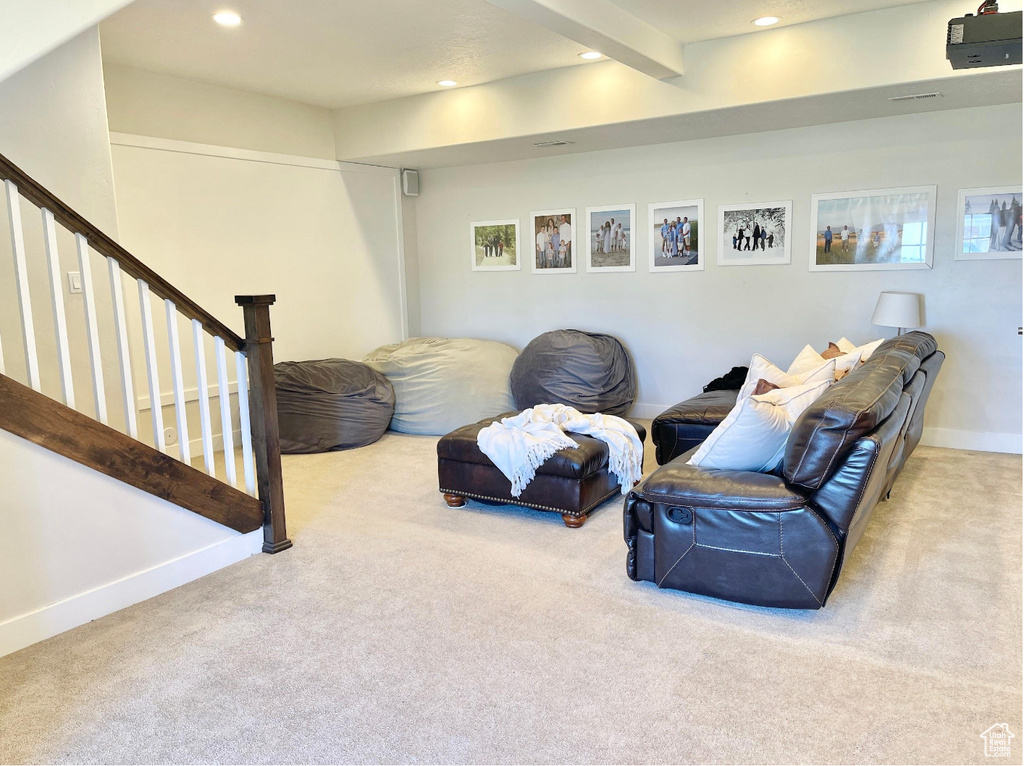 Sitting room featuring carpet, beam ceiling, recessed lighting, and stairway