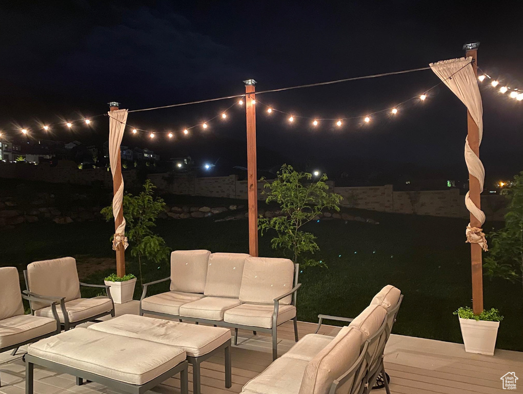 Patio at night with outdoor lounge area and a patio area