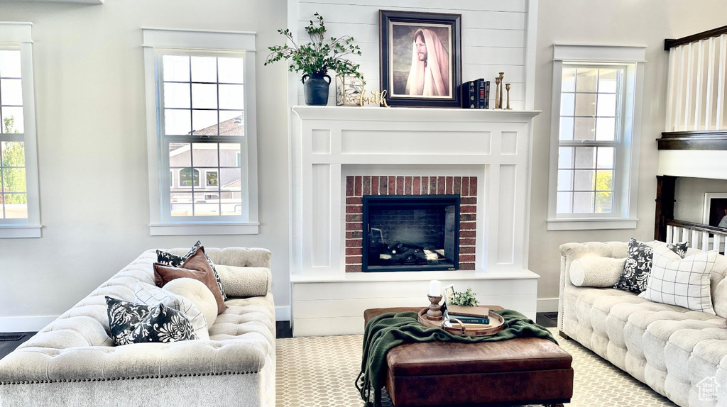 Living area with a fireplace and carpet