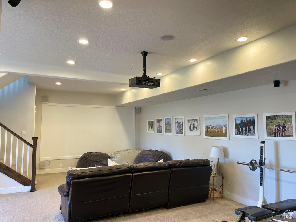 Home theater featuring light carpet, recessed lighting, and a textured ceiling