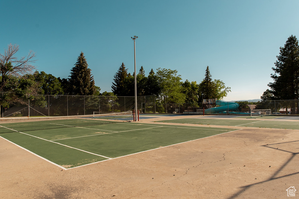 View of tennis court featuring community basketball court