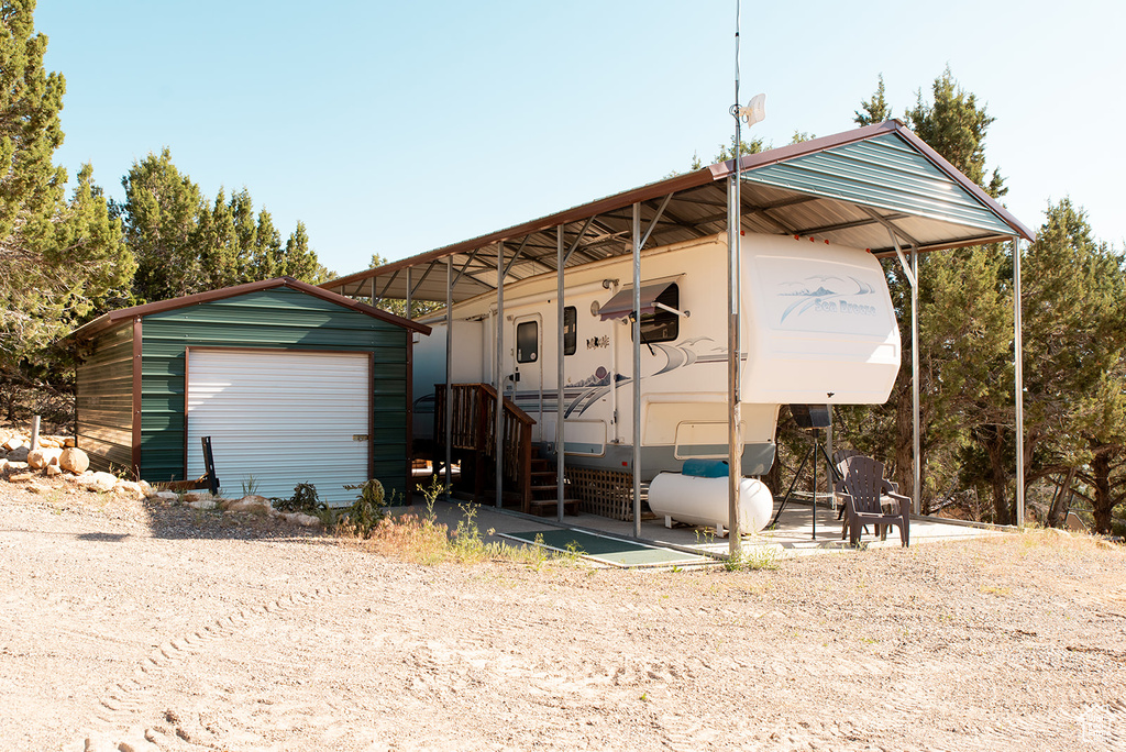 View of outbuilding with a detached carport