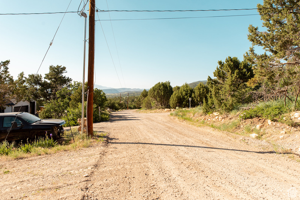View of dirt / gravel road featuring a mountain view