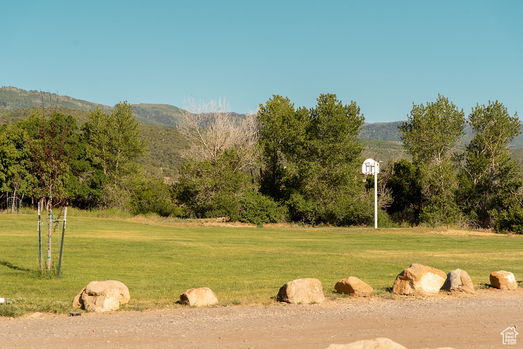 View of grassy yard featuring a mountain view