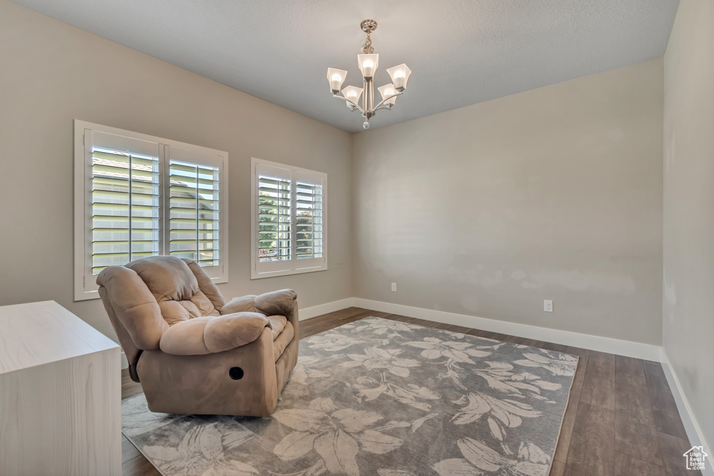 Living area with a chandelier and wood finished floors