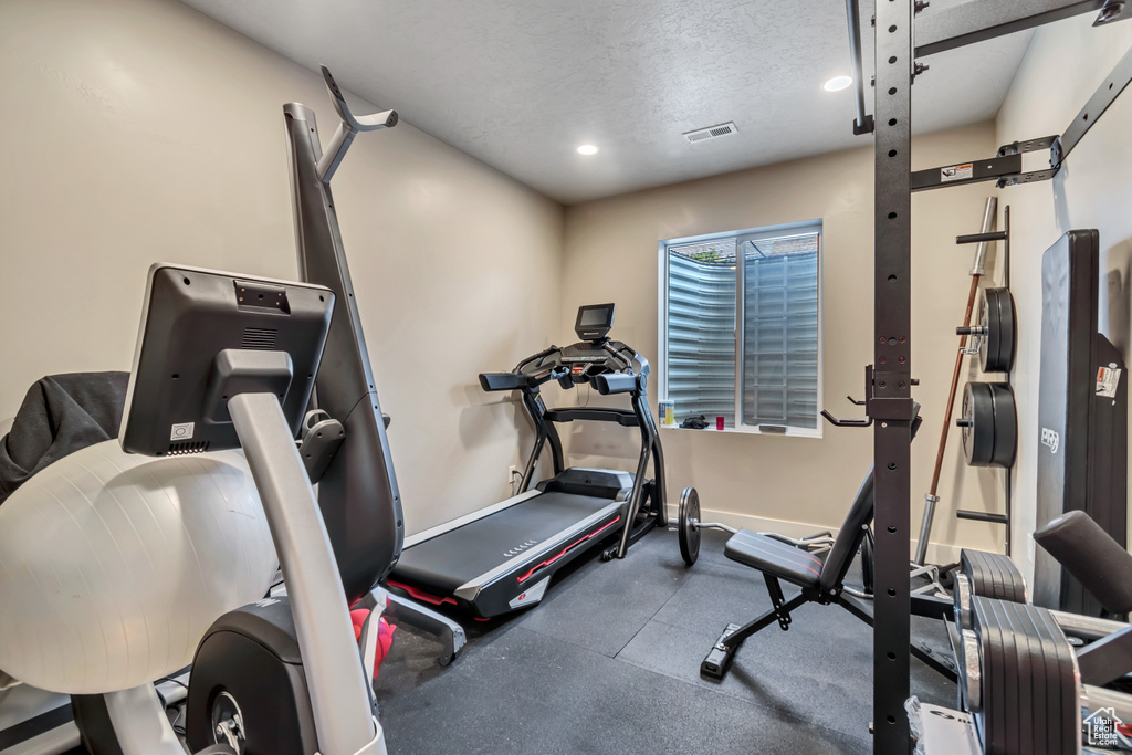 Workout area with recessed lighting and a textured ceiling