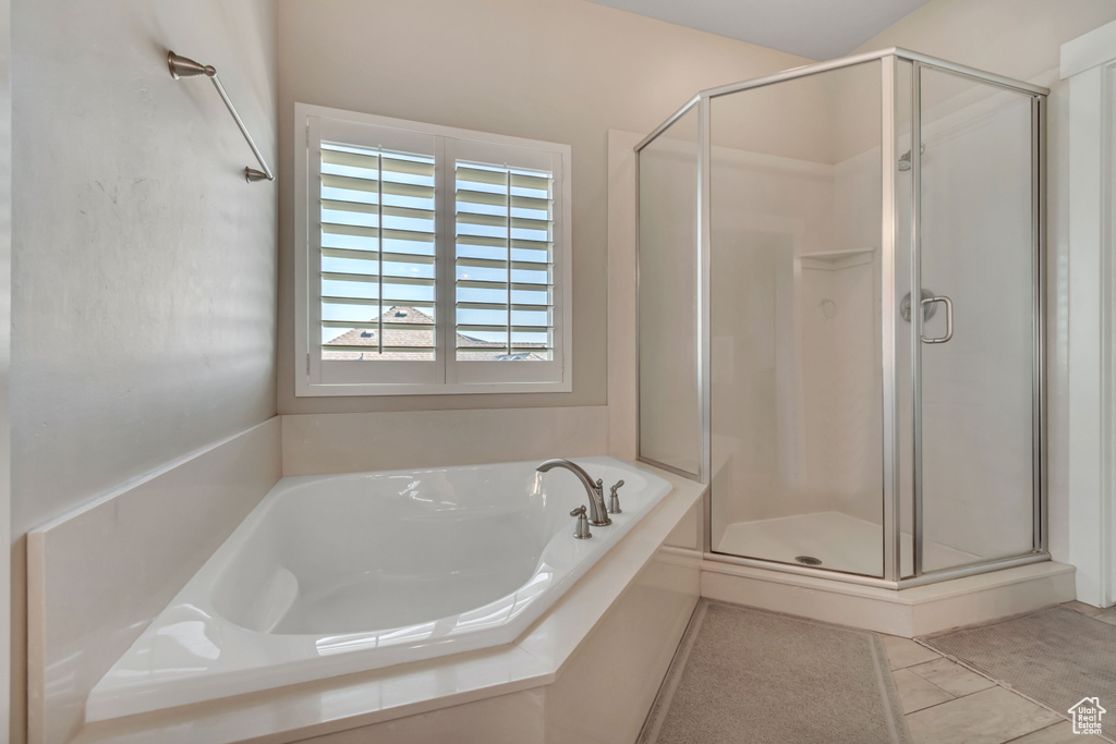 Bathroom with a shower stall, a garden tub, and tile patterned floors