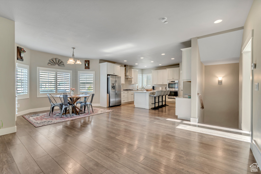 Living room featuring a chandelier, wood finished floors, and recessed lighting