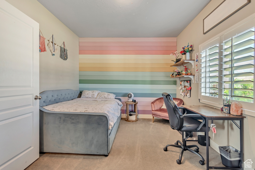 Carpeted bedroom featuring an office area