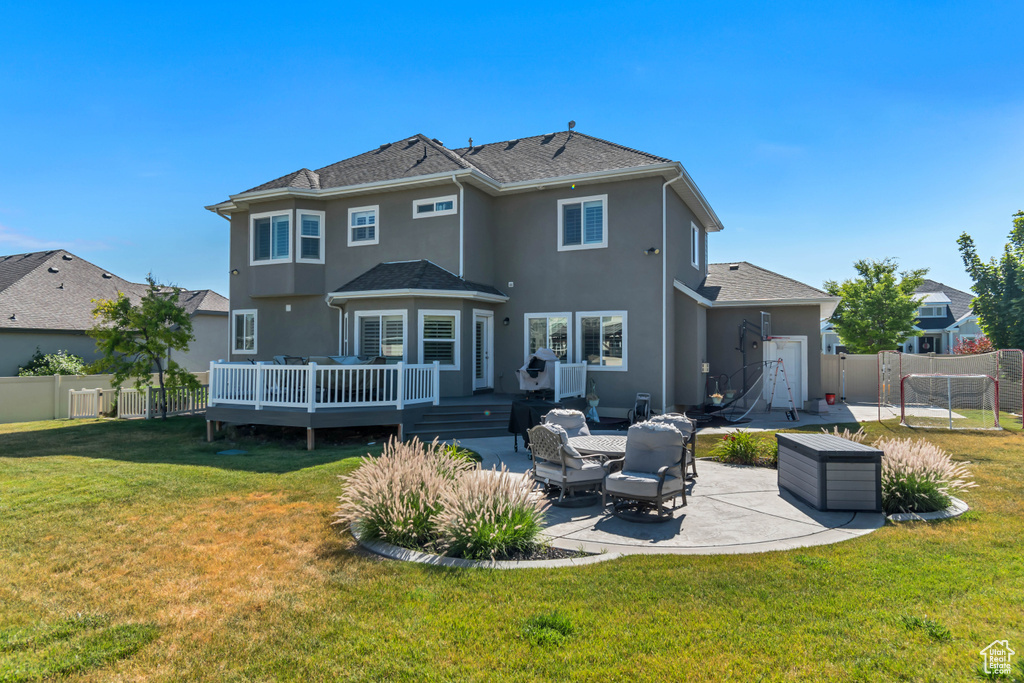 Back of property featuring stucco siding, a patio, a wooden deck, and outdoor lounge area