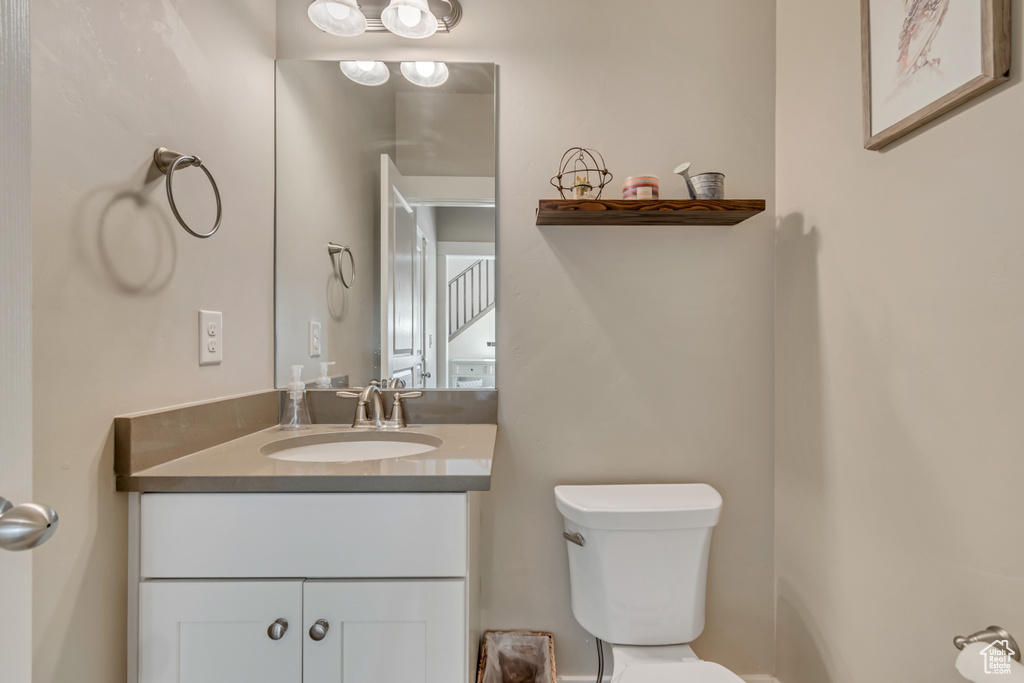 Half bathroom with toilet and vanity