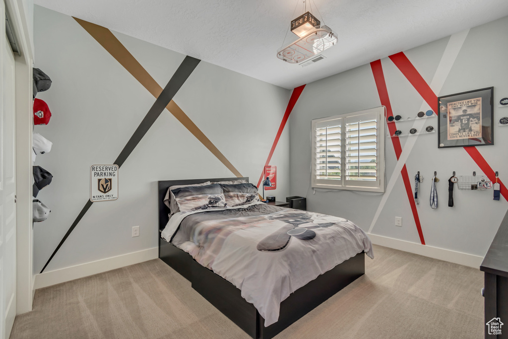 Bedroom featuring carpet flooring and baseboards