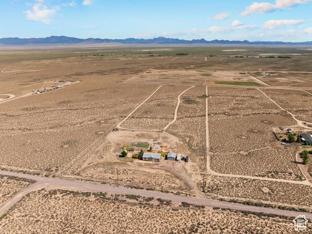 Overview of rural landscape featuring a mountain backdrop and a desert landscape
