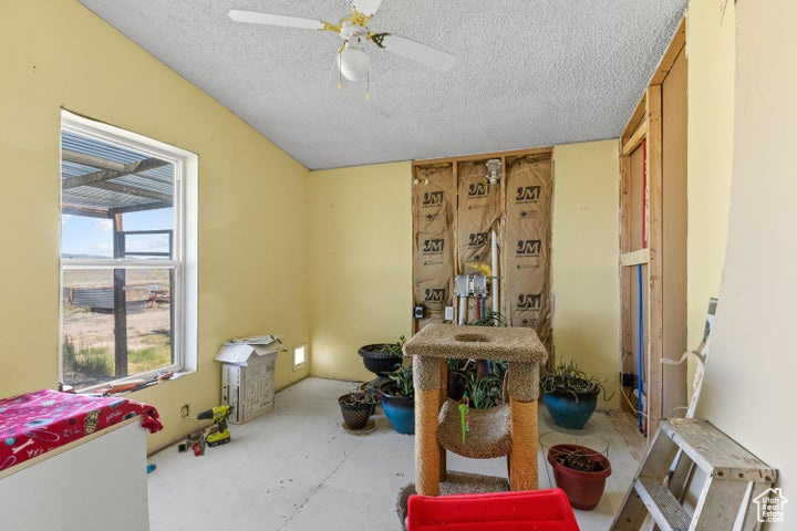 Miscellaneous room featuring a textured ceiling and ceiling fan