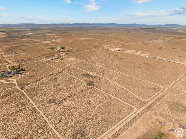 Aerial view of sparsely populated area with a desert landscape and a mountainous background