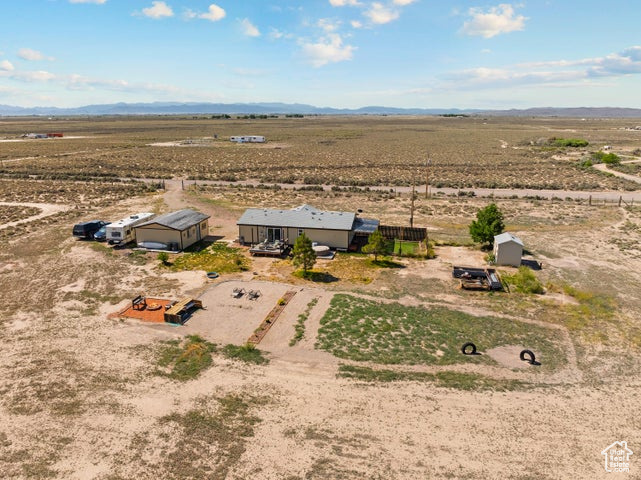 Aerial view of sparsely populated area featuring a desert landscape and a mountainous background
