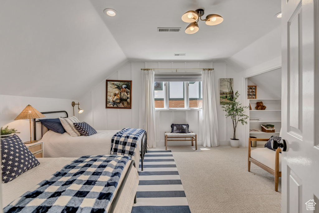 Bedroom featuring vaulted ceiling and carpet