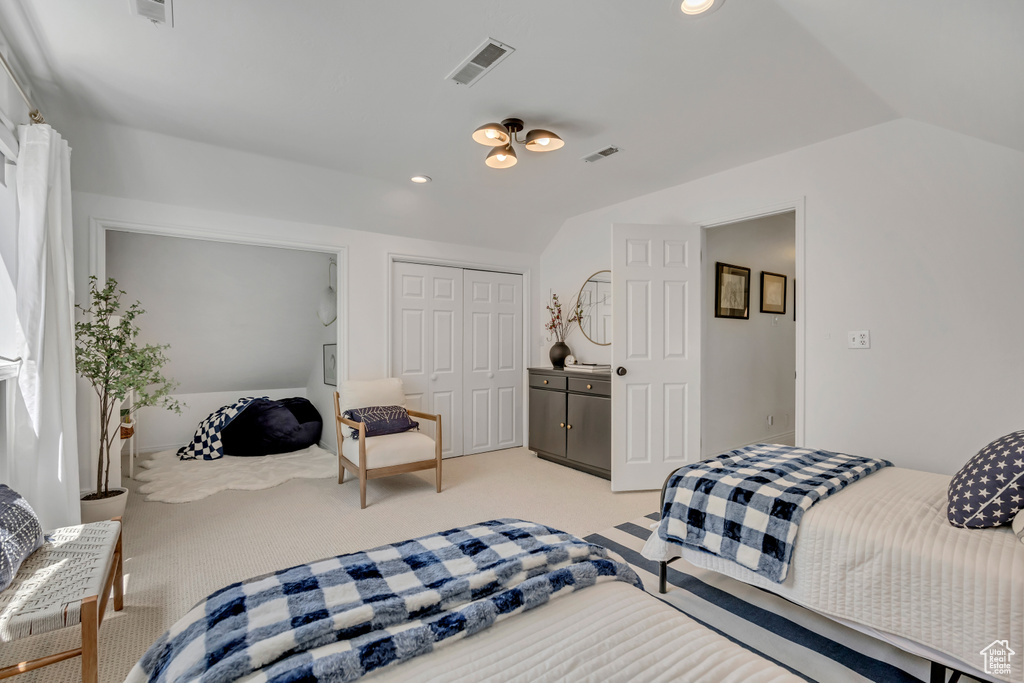 Bedroom with light carpet, vaulted ceiling, a closet, and recessed lighting