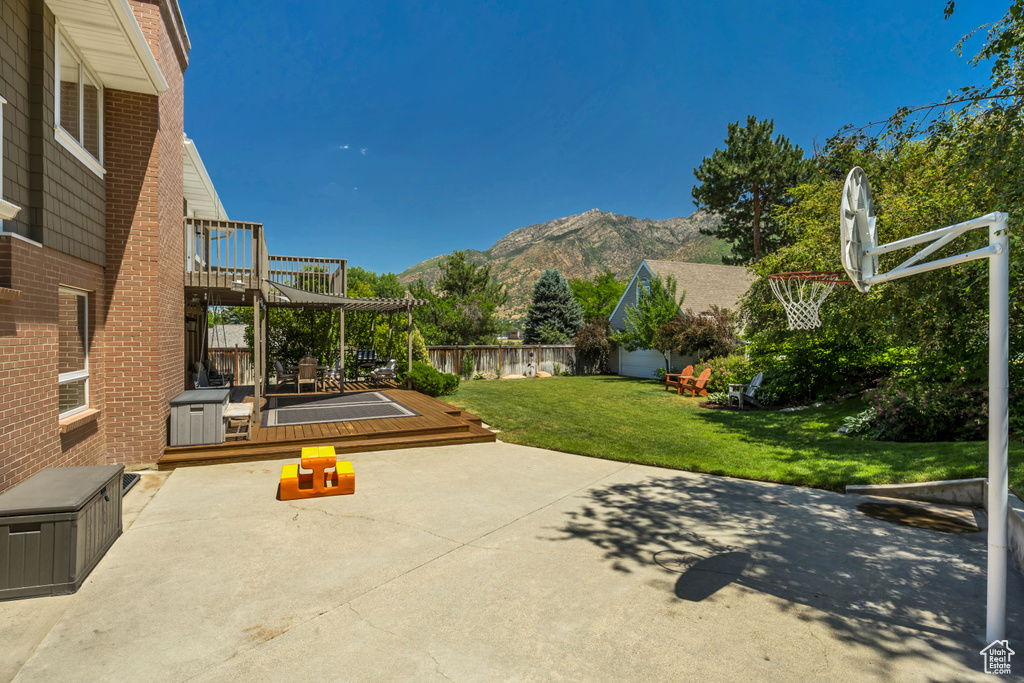 View of patio with a deck with mountain view